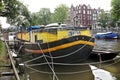 Yellow houseboat in Amsterdam