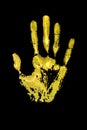 Yellow human hand print on black background isolated close up, handprint illustration, palm and fingers silhouette mark, one hand