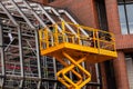 Yellow hydraulic lifting platform with bucket cabin on a telescopic lift Royalty Free Stock Photo