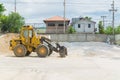 Yellow hydraulic tractor loader or Backhoe earthmover woking in