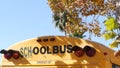 Yellow iconic school bus in Los Angeles, California USA. Classic truck for students back view. Vehicle stoplights for safety of Royalty Free Stock Photo