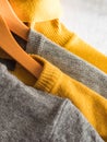 Yellow illuminated color and gray winter sweaters