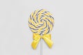 Yellow Illuminating and Ultimate Gray lolipop with wooden stick on background , childhood sweets and color of the year 2021