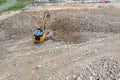 Yellow industrial excavator working on construction site. Aerial view. Royalty Free Stock Photo