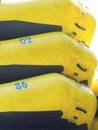 Yellow inflatable boats stacked on top of each other.