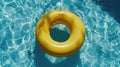 A yellow inflatable ring is floating in a pool Royalty Free Stock Photo
