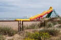 Yellow inflatable slide on beach sand