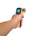 Yellow Infrared thermometer gun in hand used to measure temperature on white