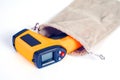 Yellow Infrared thermometer gun used to measure temperature on white background