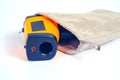 Yellow Infrared thermometer gun used to measure temperature on white