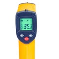 Yellow Infrared thermometer gun used to measure temperature on white