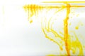 Yellow ink swirling in water, Color drop in water photographed in motion