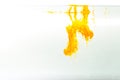 Yellow ink swirling in water, Color drop in water photographed in motion Royalty Free Stock Photo