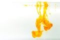 Yellow ink swirling in water, Color drop in water photographed in motion Royalty Free Stock Photo