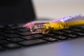 Yellow internet switch , glowing optical fibres, close up macro shot on laptop computer keyboard Royalty Free Stock Photo