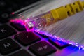 Yellow internet switch , glowing optical fibres, close up macro shot on laptop Royalty Free Stock Photo