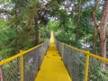 A yellow iron bridge to get to the other side of the lake Royalty Free Stock Photo