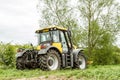 Yellow JCB Fastrac tractor parked by hedge