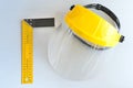 Yellow joiner`s ruler and face shield for home workshop