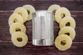 Yellow juicy pineapple rings and a can. Caramelized canned pineapple. Raw food diet. Close-up plan. Woody background. Royalty Free Stock Photo