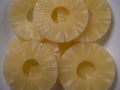 Yellow juicy pineapple rings on a white plate close up. Raw food diet. Royalty Free Stock Photo