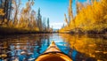 Yellow kayak sailing down a river on a sunny autumn day with yellow foliage trees.AI generated