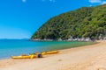 Yellow kayaks at Onetahuti beach at Abel Tasman national park in New Zealand