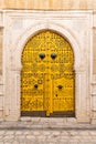 A yellow keyhole, or Moorish, arch door on a house near the Tunis Souk