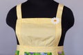 Yellow kitchen female apron on mannequin Royalty Free Stock Photo