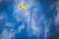 Yellow kite against bright blue sky Royalty Free Stock Photo