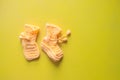 Yellow knitted child socks. Handmade wollen socks on yellow background. Royalty Free Stock Photo