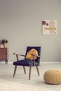 Yellow knot pillow on trendy vintage armchair
