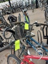 Yellow labels from the municipality of Zuidplas on bicycle wrecks at the station to warn against removal