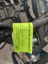 Yellow labels from the municipality of Zuidplas on bicycle wrecks at the station to warn against removal