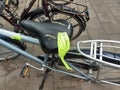 Yellow labels from the municipality of Zuidplas on bicycle wrecks at the station to warn against removal