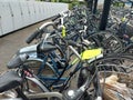 Yellow labels from the municipality of Zuidplas on bicycle wrecks at the station to warn against removal