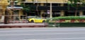Yellow Lamborghini Gallardo driving very fast on the street. motion blur