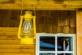 Yellow lantern hanging on the roof of a cottage, basic camp lighting