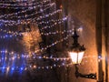 yellow lantern lamp on old house wall street illumination and light blurred on wet pavement in medieval  Christmas decoration Tal Royalty Free Stock Photo