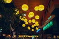 Yellow lanterns on the ceiling in front of a hotel in Thailand at night