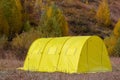 Yellow large basecamp tent on colorful mountains background