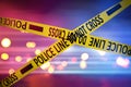 Yellow law enforcement tape isolating crime scene. Blurred background with red and blue police car lights Royalty Free Stock Photo