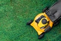 Yellow lawn mowers cut green grass. Royalty Free Stock Photo