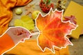 yellow leaf with heart in female hand, tea, coffee in a mug on the table in the garden, colored letter words, the concept of Royalty Free Stock Photo