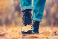 Yellow leaf stuck to the women`s shoe during a walk through the autumn forest. Royalty Free Stock Photo