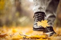 Yellow leaf stuck to the women`s shoe during a walk through the autumn forest. Royalty Free Stock Photo