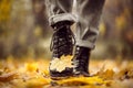 Yellow leaf stuck to the women`s shoe during a walk through the autumn forest. Royalty Free Stock Photo