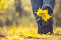 Yellow leaf stuck to the women`s shoe during a walk through the autumn forest. Royalty Free Stock Photo