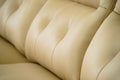 Yellow leather sofa, close up detail with buttons. Furniture showroom photography Royalty Free Stock Photo