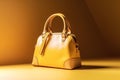 Yellow leather women\'s handbag on a yellow background. Studio shot.